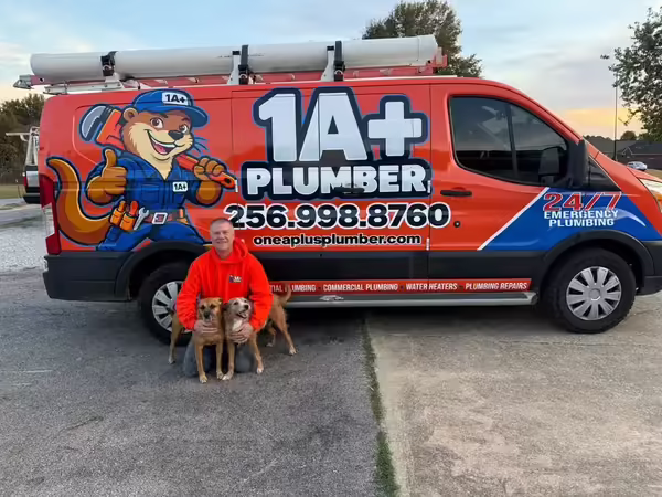 Eric Walts with his pups beside the 1 A+ Plumber service van